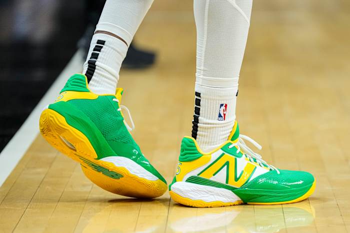 Atlanta Hawks guard Dejounte Murray's green and yellow New Balance shoes.